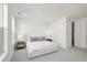 Bright bedroom featuring a minimalist design with white walls, plush carpeting, and ample natural light from the window at 1815 N Williams St, Denver, CO 80218