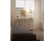 A dresser is topped with a lamp and plant in a sunlit bedroom with a floral print hanging above it at 1815 N Williams St, Denver, CO 80218