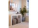 Hallway with art and a stylish console table with ottomans beneath at 1815 N Williams St, Denver, CO 80218