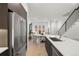 Modern kitchen with stainless steel appliances and an island that overlooks the dining area at 1815 N Williams St, Denver, CO 80218