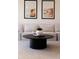 Bright living room featuring a stylish round coffee table and neutral-toned sofa with coastal artwork at 1815 N Williams St, Denver, CO 80218