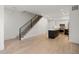 Modern living room showcases a staircase with black railings and an eat-in kitchen with stainless steel appliances at 1815 N Williams St, Denver, CO 80218