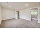 Spacious carpeted basement with neutral walls, providing a versatile living area with view into the closet area at 7325 Taft Ct, Arvada, CO 80005
