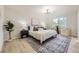 Bright bedroom with a large window, soft rug, contemporary lighting, and tasteful decor at 7325 Taft Ct, Arvada, CO 80005