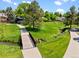 Park walking path with wooden bridge over stream with beautiful mature trees and landscaping at 7325 Taft Ct, Arvada, CO 80005
