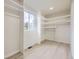 Bright, airy closet with custom shelving and a window providing natural light at 7325 Taft Ct, Arvada, CO 80005