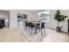 Bright dining area featuring modern lighting, wood floors, and large windows at 7325 Taft Ct, Arvada, CO 80005