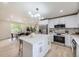 White kitchen with stainless steel appliances, granite countertops and eat-in dining area at 7325 Taft Ct, Arvada, CO 80005