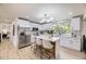 Kitchen with island, white cabinets and stainless appliances at 7325 Taft Ct, Arvada, CO 80005