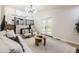 Open-concept living area with wood floors, stairs, and french doors at 7325 Taft Ct, Arvada, CO 80005