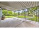 Covered patio featuring decorative metal posts, with a concrete floor and views of the lush backyard at 7325 Taft Ct, Arvada, CO 80005