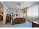Cozy bedroom featuring plush bed, vintage dresser, and carpeted floors at 5155 W Quincy Ave # L101, Denver, CO 80236