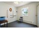 Neutral bedroom featuring grab bars, bright window, and carpeted floors at 5155 W Quincy Ave # L101, Denver, CO 80236
