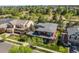 A bird's eye view highlights the exterior, displaying well-maintained landscaping and a cozy backyard retreat at 13324 W 86Th Dr, Arvada, CO 80005