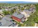 Beautiful aerial view of a red two-story house with a gray roof in a suburban neighborhood near a lake and mountains at 13324 W 86Th Dr, Arvada, CO 80005