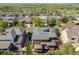 Aerial view of a red two-story home with a gray roof featuring a spacious yard and deck at 13324 W 86Th Dr, Arvada, CO 80005