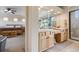 Primary bathroom features a double sink vanity, glass enclosed shower, and a soaking tub with window views at 13324 W 86Th Dr, Arvada, CO 80005