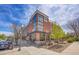 Modern, attractive brick commercial building with large glass windows and outdoor seating area, street view at 13324 W 86Th Dr, Arvada, CO 80005