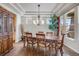 Elegant dining room with hardwood floors, coffered ceiling, and large windows at 13324 W 86Th Dr, Arvada, CO 80005