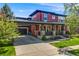 Charming two-story home featuring a covered porch, attached garage, and well-maintained landscaping at 13324 W 86Th Dr, Arvada, CO 80005