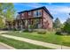Beautiful two-story home with a welcoming front porch and lush green lawn at 13324 W 86Th Dr, Arvada, CO 80005