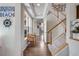 Inviting foyer with hardwood floors, staircase, and plenty of natural light at 13324 W 86Th Dr, Arvada, CO 80005