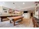 Spacious game room area with pool table, shuffle board and bar, perfect for entertaining at 13324 W 86Th Dr, Arvada, CO 80005