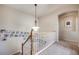 Upstairs hallway with a charming display of Gathering photos along the wall and staircase at 13324 W 86Th Dr, Arvada, CO 80005
