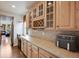 Kitchen with cabinets, tile countertops, and a wine rack creates a stylish space for cooking and entertaining at 13324 W 86Th Dr, Arvada, CO 80005