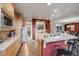 Open kitchen with wood cabinets and stainless steel appliances complements the stylish, connected living space at 13324 W 86Th Dr, Arvada, CO 80005