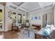 Cozy living room featuring hardwood floors, coffered ceiling, and ample natural light at 13324 W 86Th Dr, Arvada, CO 80005