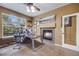 Functional office featuring a fireplace, two monitors, and a comfortable chair at 13324 W 86Th Dr, Arvada, CO 80005