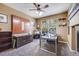 Well-lit office space with built-in shelving, a fireplace, and a large window at 13324 W 86Th Dr, Arvada, CO 80005