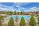 A large community pool with clear blue water surrounded by greenery and lounge areas for residents to relax at 13324 W 86Th Dr, Arvada, CO 80005