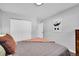 Neutral bedroom with a closet and modern art piece on wall at 4501 Bryant St, Denver, CO 80211