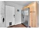 Kitchen featuring stainless steel refrigerator, light wood cabinets, and laundry area at 4501 Bryant St, Denver, CO 80211