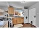 Well-lit kitchen featuring modern appliances and light wood cabinets and access to the laundry at 4501 Bryant St, Denver, CO 80211