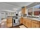 Open kitchen featuring stainless steel appliances, light wood cabinets, and a mosaic backsplash at 4501 Bryant St, Denver, CO 80211