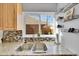 Close-up on the kitchen sink with granite countertops, tiled backsplash, and backyard view at 4501 Bryant St, Denver, CO 80211