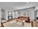 Spacious living room featuring a leather couch, wooden coffee table, and a large window at 4501 Bryant St, Denver, CO 80211