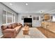 Cozy living room featuring a leather couch, wooden coffee table and an area rug at 4501 Bryant St, Denver, CO 80211