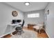 Home office with a desk setup, rolling chair, and a classic wooden storage trunk at 4501 Bryant St, Denver, CO 80211