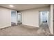 Finished basement with multiple doors and neutral colored carpet at 8408 W 62Nd Pl, Arvada, CO 80004