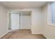 Basement area with two doors, small window and neutral carpet at 8408 W 62Nd Pl, Arvada, CO 80004