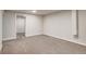 View of the finished basement with carpet and a door at 8408 W 62Nd Pl, Arvada, CO 80004