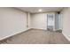 View of the finished basement with neutral paint and carpet at 8408 W 62Nd Pl, Arvada, CO 80004