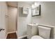 Bathroom with neutral colored walls, mirror, vanity and toilet at 8408 W 62Nd Pl, Arvada, CO 80004