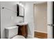 Updated bathroom featuring vanity sink with dark wood cabinets and neutral wall color at 8408 W 62Nd Pl, Arvada, CO 80004