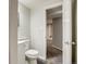 Bathroom with toilet and vanity, door opening into another room at 8408 W 62Nd Pl, Arvada, CO 80004