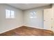 This bedroom features wood floors and dual windows for natural light at 8408 W 62Nd Pl, Arvada, CO 80004